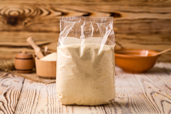 semolina packing bowl wooden background healthy dietary cereals concept - Старорусские блины на молочной сыворотке