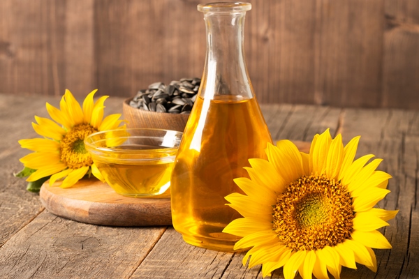 sunflower oil with seeds wooden background - Маринованная капуста по-петровски