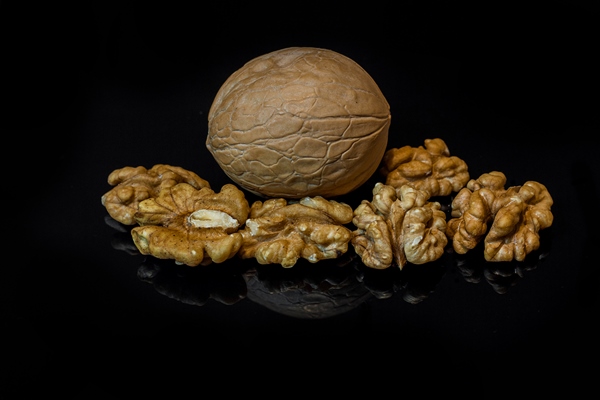 walnuts isolated black background with reflection - Тыквенный кисель с грецкими орехами