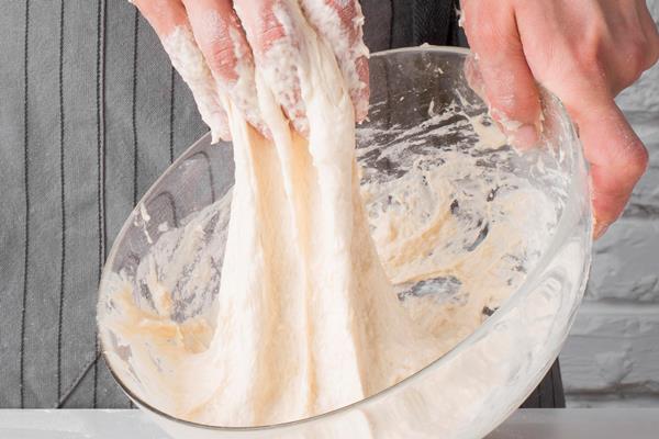 woman kneading dough bowl - Пончики дрожжевые с начинкой