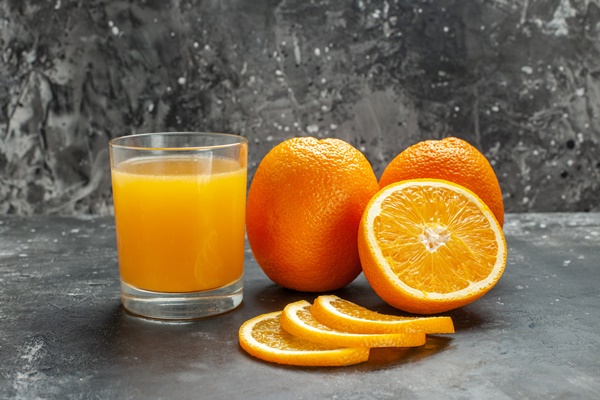 close up view vitamin source cut chopped whole fresh oranges gray background - Апельсиновое печенье