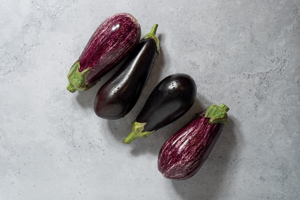 flat lay raw eggplants still life - Баклажаны имам баялди