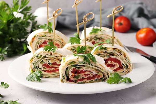 lavash roll with cucumbers tomatoes cheese and parsley on gray background festive appetizer - Блюда из икры на Лазареву субботу