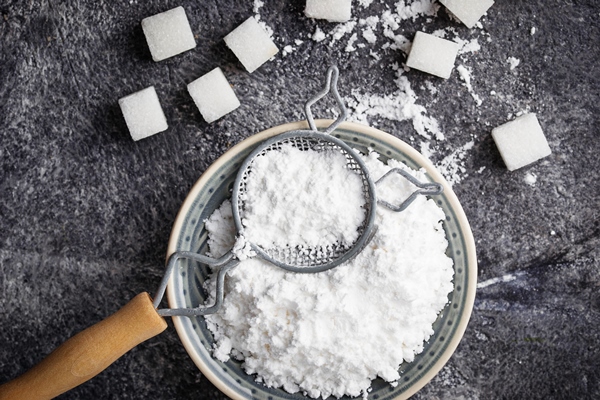 sugar powder concrete background selective focus - Миндальные конфеты