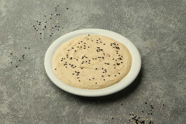 turkish side dish topped with black white sesame grey background 1 - Бутербродная ореховая паста по-афонски